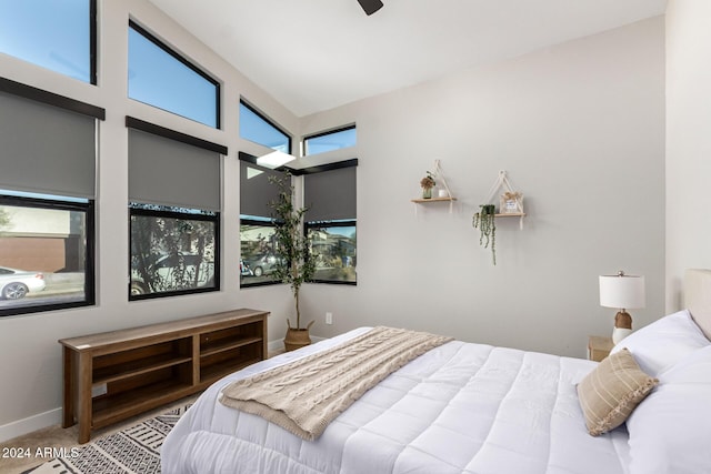 bedroom with vaulted ceiling, carpet floors, and multiple windows