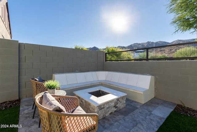 view of patio featuring a mountain view and a fire pit