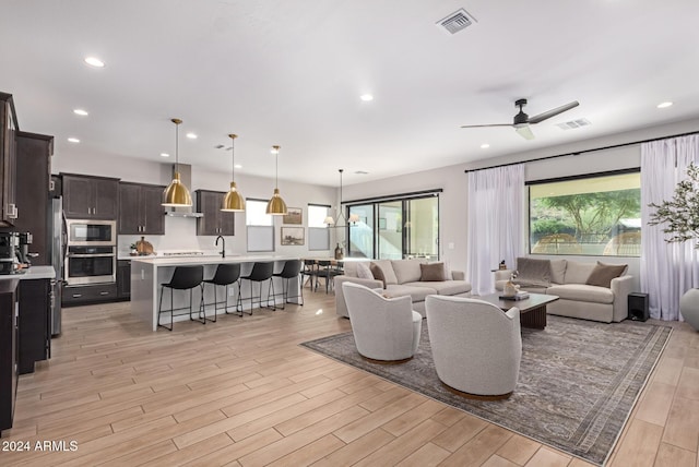 living room featuring plenty of natural light and ceiling fan