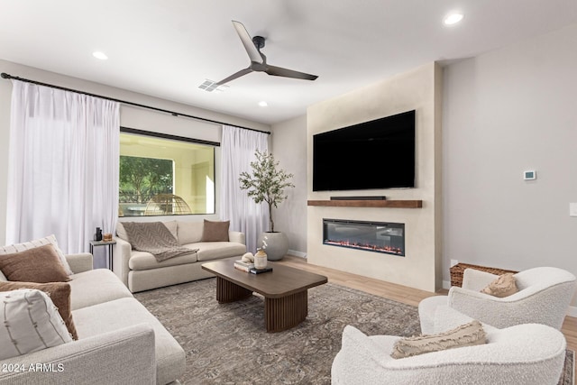 living room with ceiling fan and hardwood / wood-style flooring