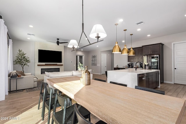 dining room featuring ceiling fan and sink