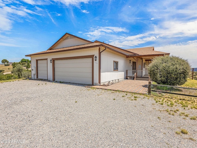 single story home featuring an attached garage, covered porch, and driveway