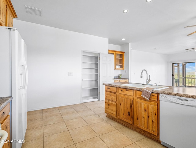 kitchen featuring white appliances, visible vents, light tile patterned flooring, recessed lighting, and a sink