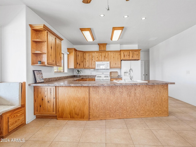 kitchen featuring a sink, open shelves, white appliances, a peninsula, and light tile patterned flooring