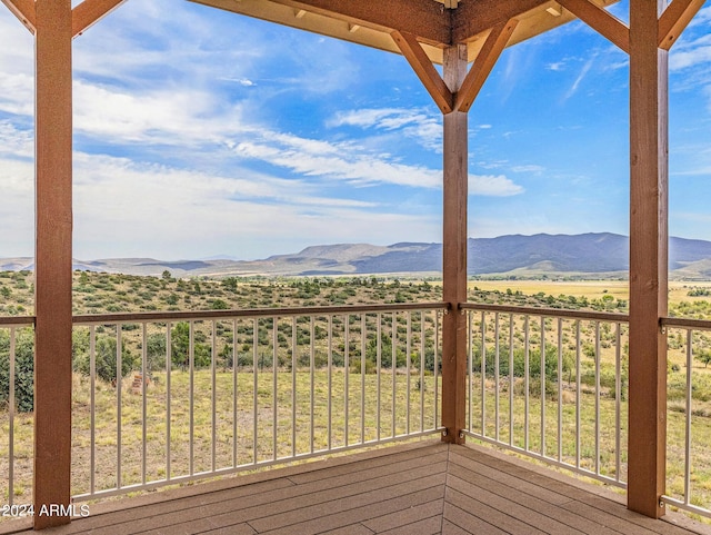 wooden deck featuring a mountain view