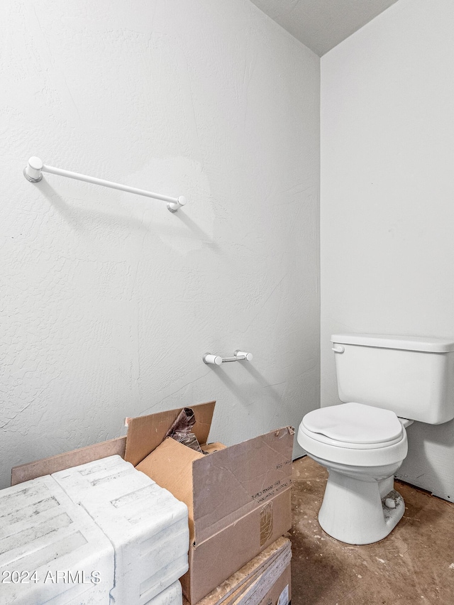 bathroom with toilet and concrete floors