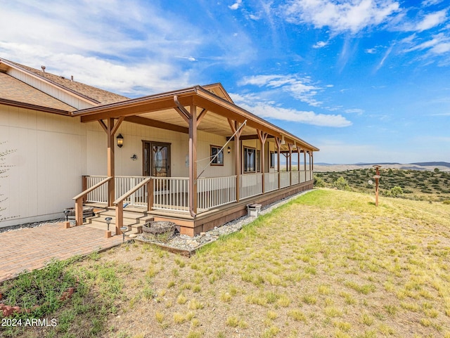 exterior space featuring a porch and a lawn