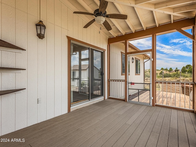 unfurnished sunroom featuring ceiling fan and vaulted ceiling