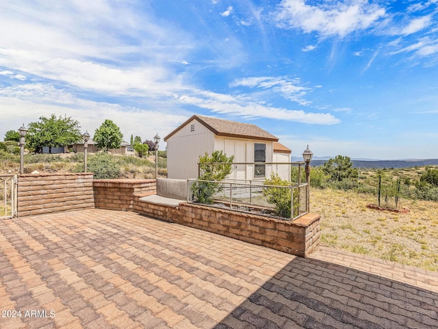 view of patio featuring an outbuilding