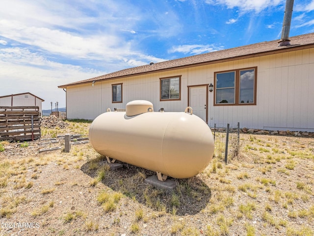 rear view of house featuring fence