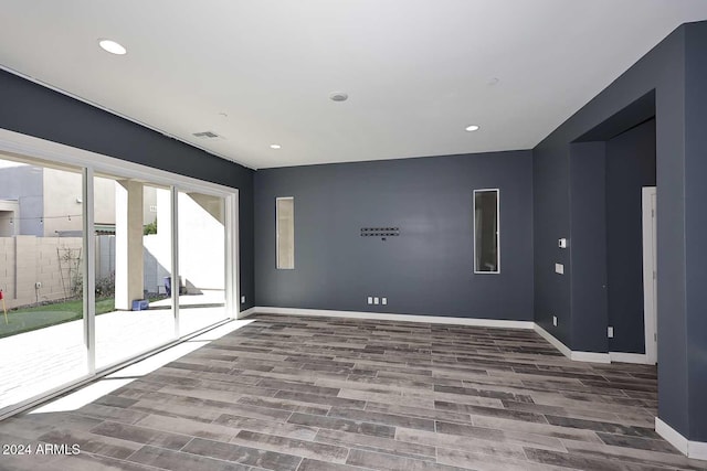 spare room featuring wood-type flooring