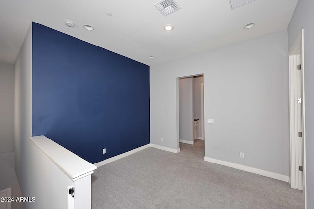 unfurnished room featuring light colored carpet