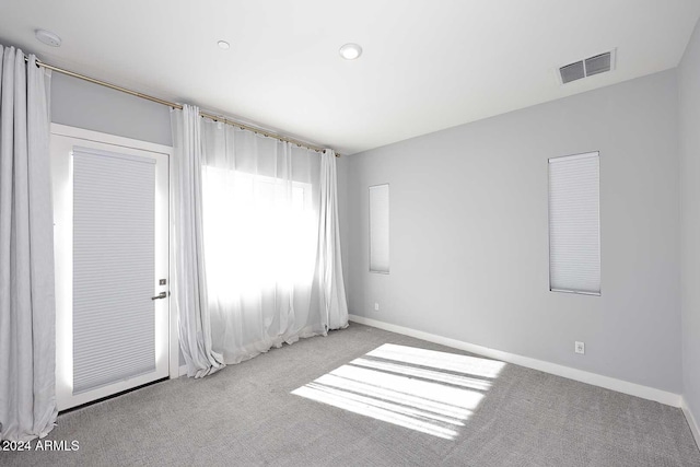 unfurnished room with light colored carpet