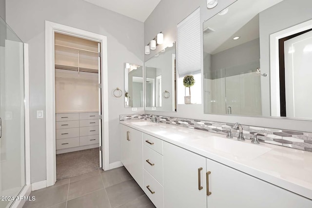 bathroom featuring tile patterned flooring, vanity, and an enclosed shower