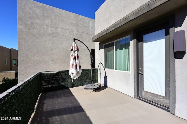 view of patio featuring a balcony