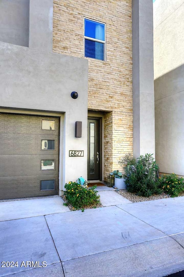 view of exterior entry featuring a garage