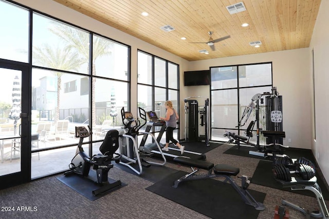 workout area featuring plenty of natural light, ceiling fan, and wooden ceiling