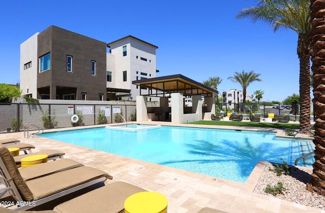 view of pool with a patio area and a hot tub