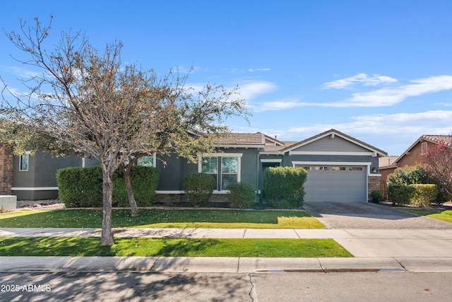 view of front of house featuring a garage and a front lawn