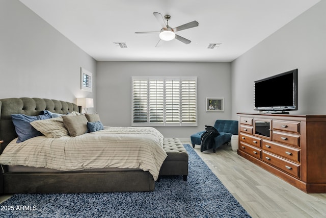 bedroom with light hardwood / wood-style flooring and ceiling fan