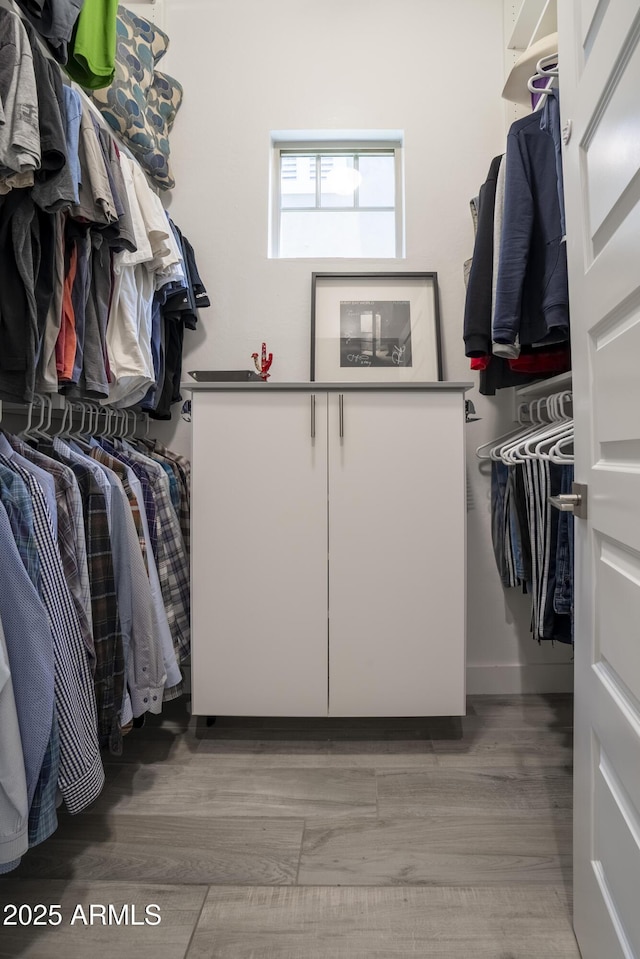 spacious closet featuring light hardwood / wood-style floors