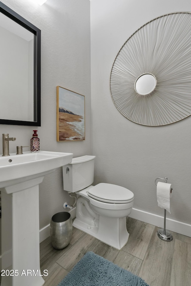 bathroom featuring sink, toilet, and hardwood / wood-style floors