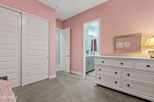 bedroom featuring light colored carpet, connected bathroom, and a closet