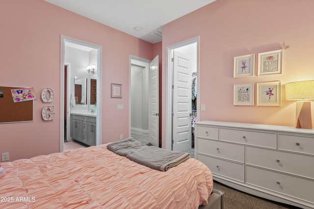 bedroom featuring sink, a spacious closet, connected bathroom, and a closet