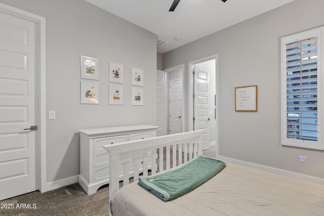 bedroom featuring ceiling fan and dark colored carpet