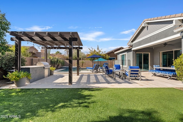 view of patio featuring ceiling fan, a grill, a pergola, and exterior kitchen