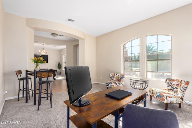 office area featuring light carpet and a chandelier