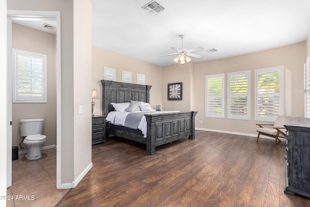 bedroom featuring ceiling fan, ensuite bathroom, and dark hardwood / wood-style floors