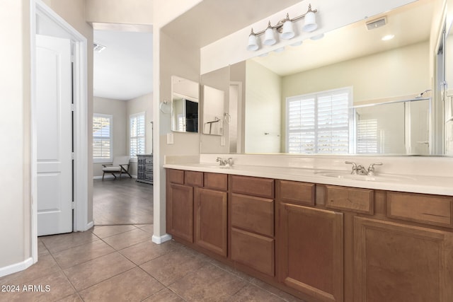 bathroom with vanity, tile patterned floors, and a shower with door