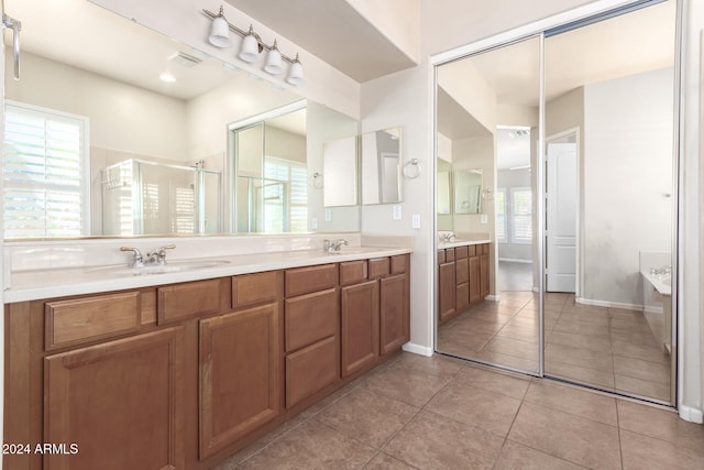 bathroom featuring vanity, tile patterned floors, and separate shower and tub