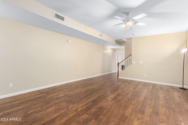 empty room with ceiling fan and dark hardwood / wood-style flooring