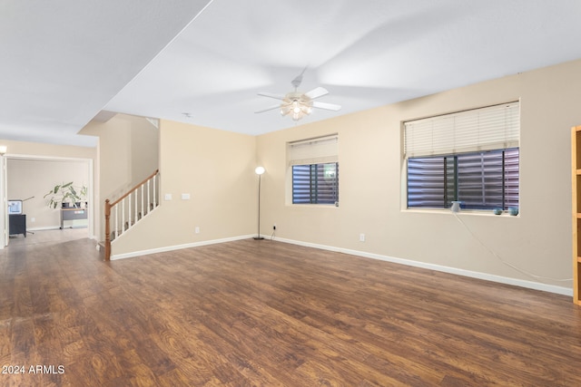 empty room featuring dark wood-type flooring and ceiling fan