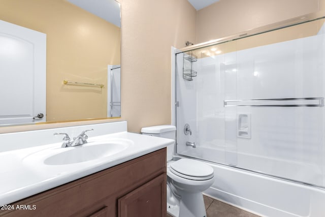 full bathroom with vanity, combined bath / shower with glass door, toilet, and tile patterned floors