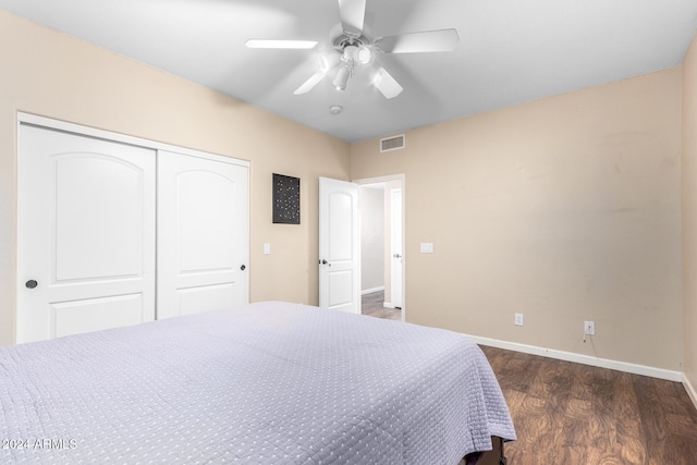 bedroom featuring a closet, ceiling fan, and dark hardwood / wood-style floors