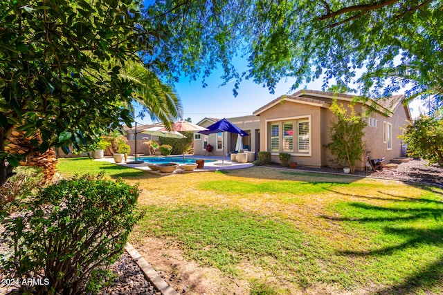 rear view of property featuring a lawn