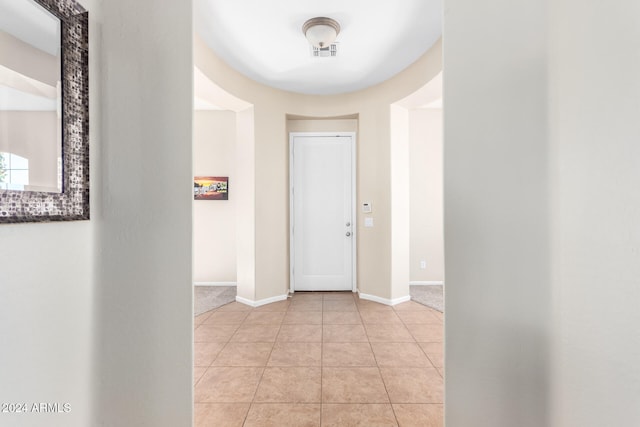 hall with light tile patterned flooring