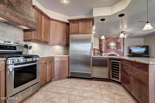 kitchen with beverage cooler, premium range hood, a peninsula, stainless steel appliances, and tasteful backsplash