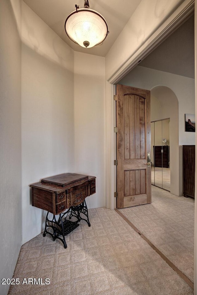 interior space with arched walkways and carpet floors