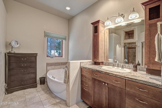 full bath with tile patterned floors, a garden tub, a stall shower, and vanity