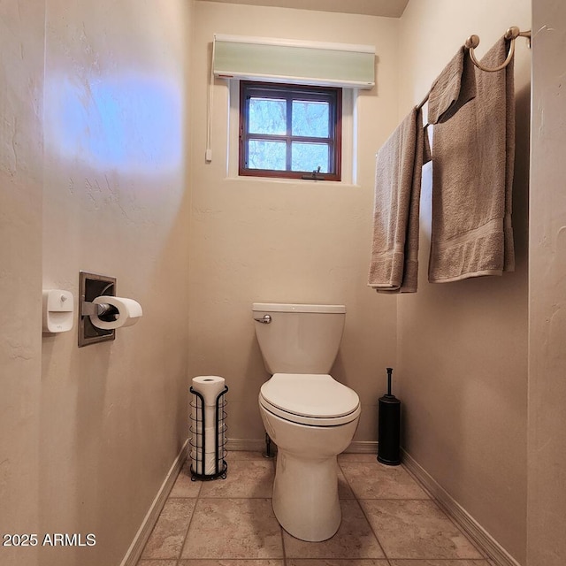 bathroom featuring toilet and baseboards