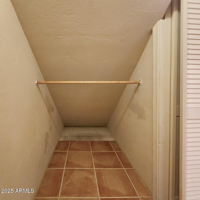 spacious closet featuring tile patterned flooring