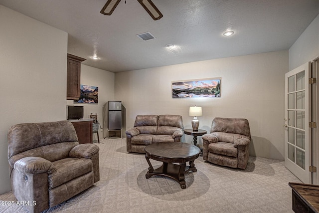 living area with visible vents, light carpet, recessed lighting, french doors, and a ceiling fan