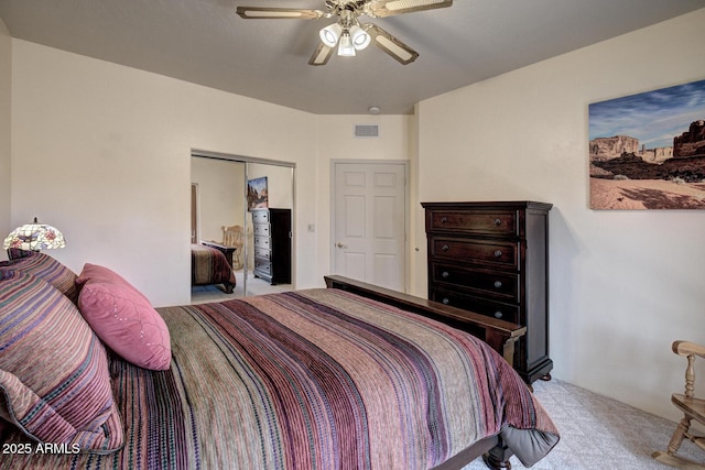 bedroom with carpet flooring, visible vents, a closet, and ceiling fan