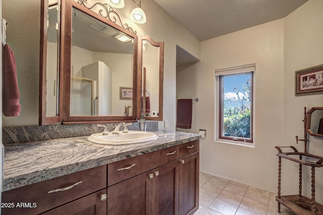 full bathroom with vanity, tile patterned floors, an enclosed shower, and visible vents