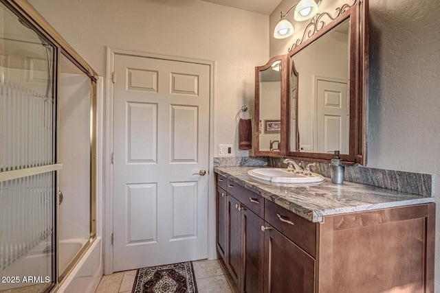 bathroom with vanity, tile patterned flooring, and enclosed tub / shower combo