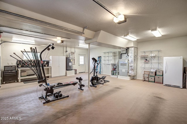 exercise room with heating unit, a textured ceiling, and electric water heater